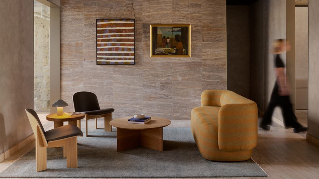 This is a hotel fitout by Unita Australia for the Garde Hotel in Fremantle. This is an image of a person walking past a sitting room.